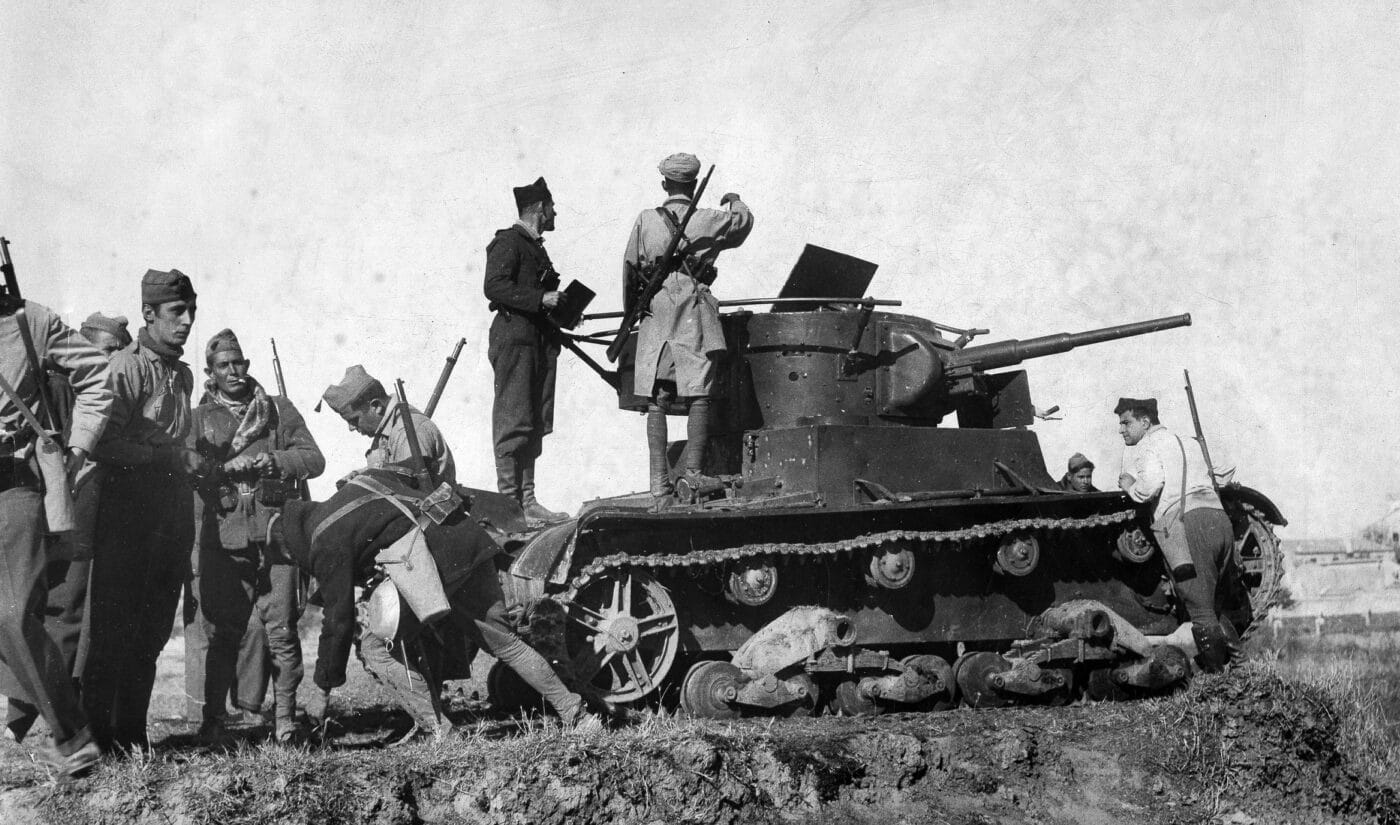 Spanish Nationalist troops look over a captured T-26 tank