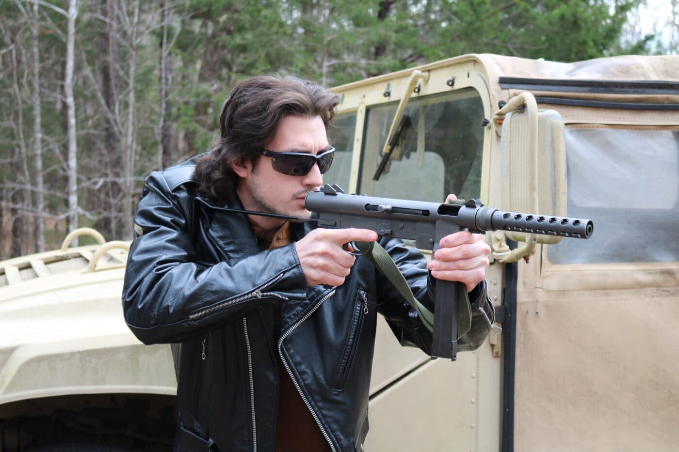 Man maneuvering with M76 9mm submachine gun