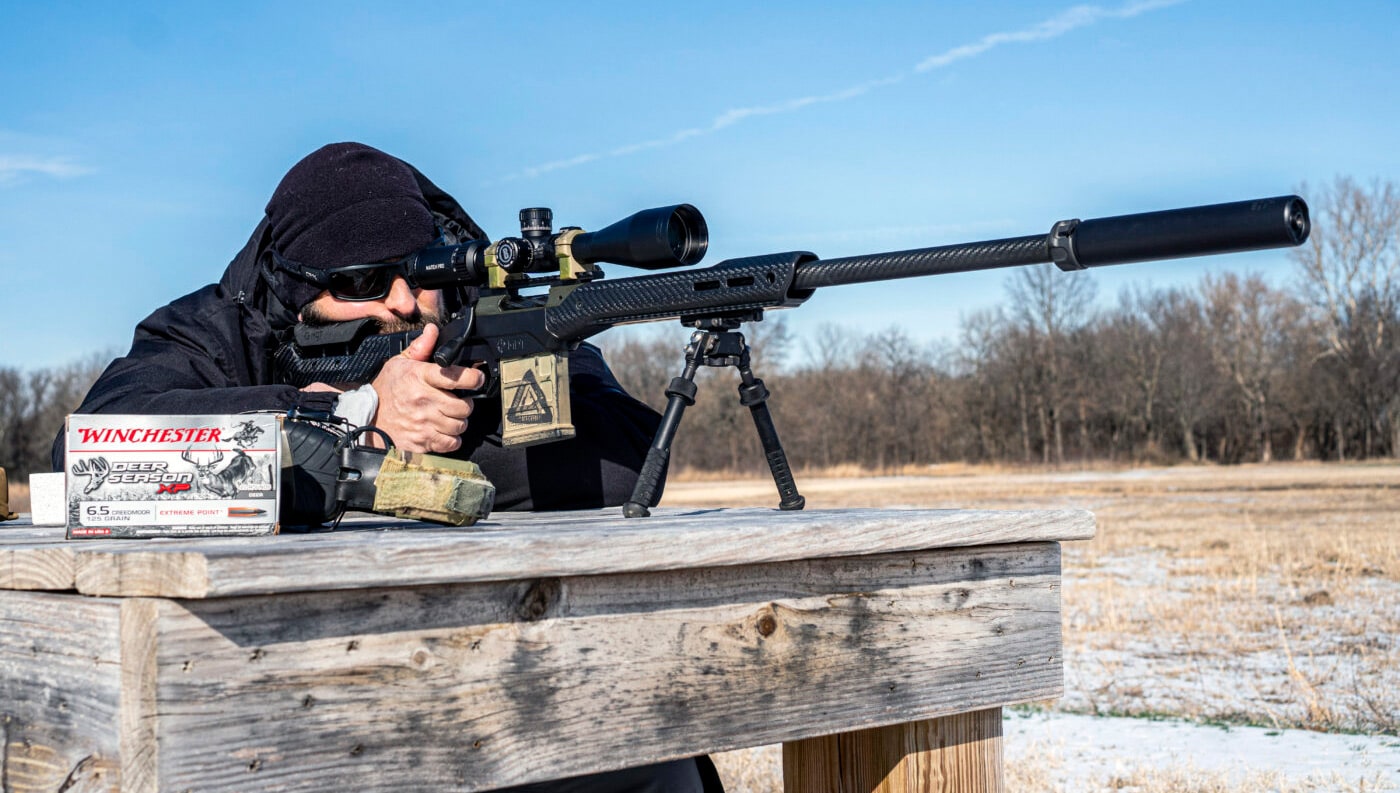 Man running accuracy tests with Surefire suppressor on Springfield Waypoint rifle