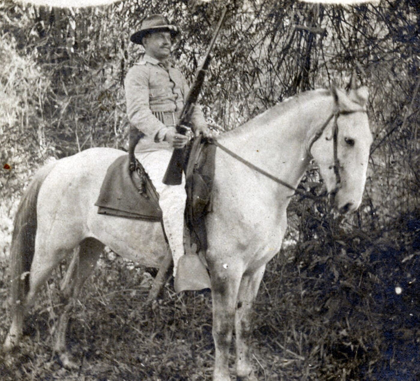 Man on a horse holding a Krag Carbine during the Spanish-American War