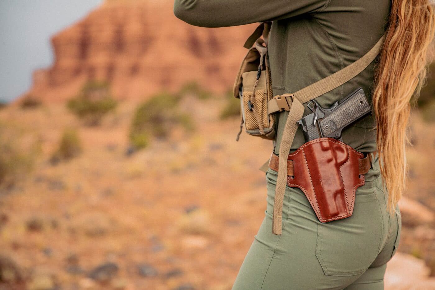 Woman hunting while carrying a 1911 pistol in a Bianchi Remedy holster