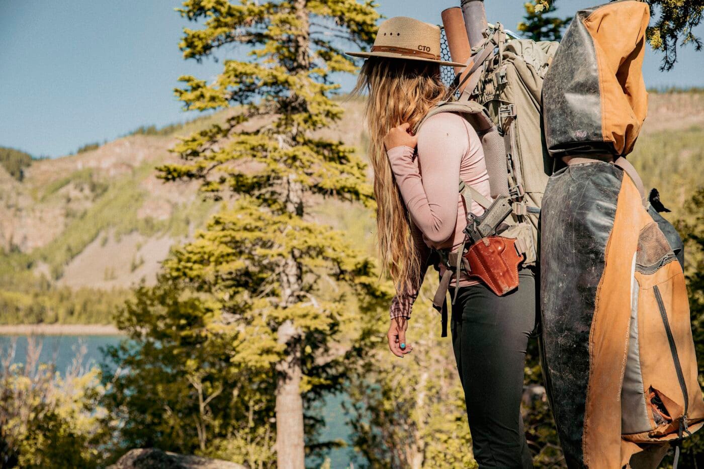 Woman hiking while carrying a Springfield Armory 1911 in a Bianchi Remedy holster