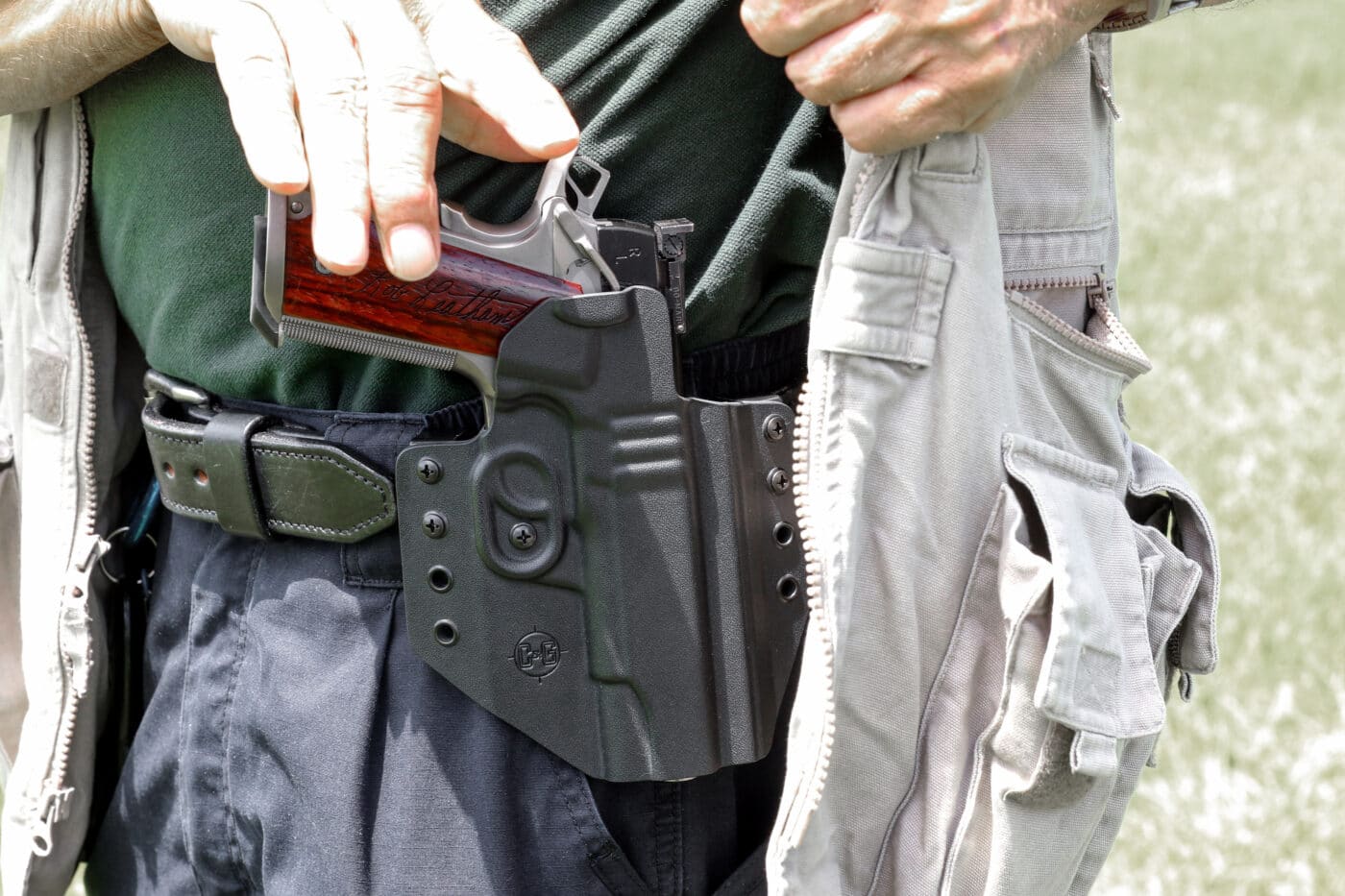 Ayoob demonstrating cross draw of pistol from holster
