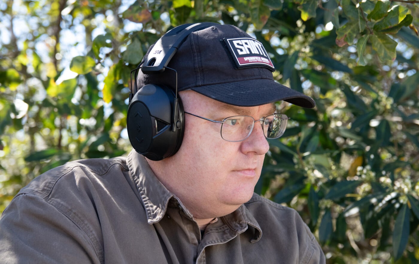 Man demonstrating proper fit of hearing muffs