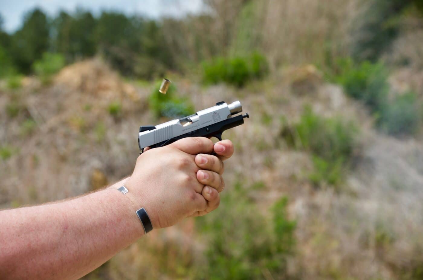 Person shooting a micro 1911 pistol