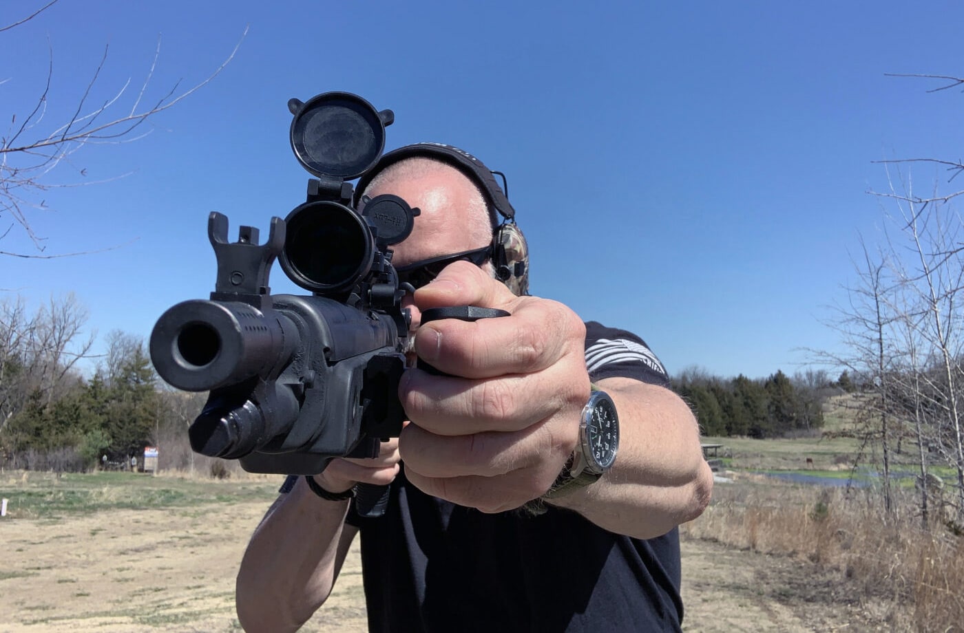 Man holding rifle with Ryker Grip installed