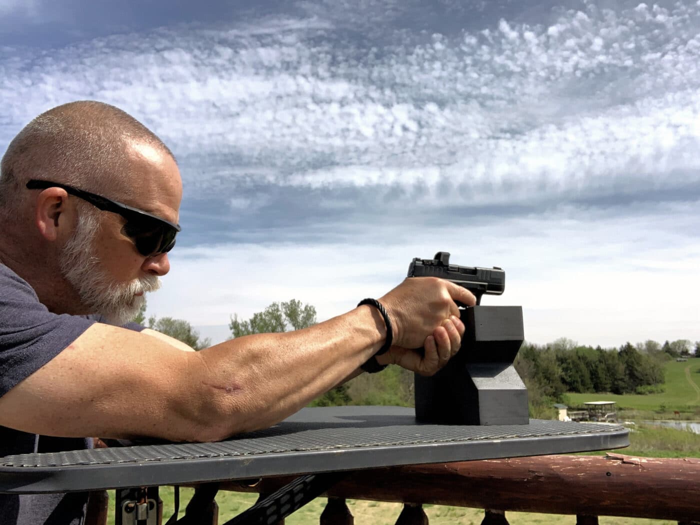 Man shooting a subcompact 9mm from a rest