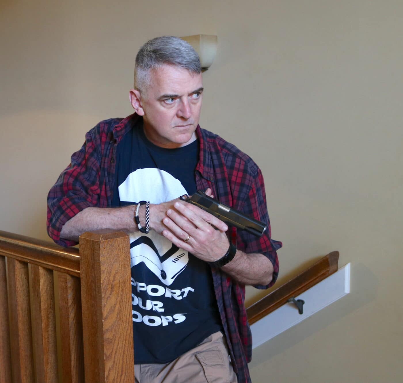 Man in stairwell with Springfield Armory 9mm Garrison 1911 pistol