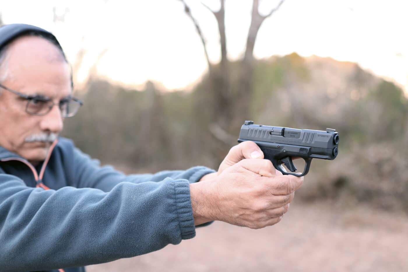 Man shooting a Hellcat micro 9mm on the range