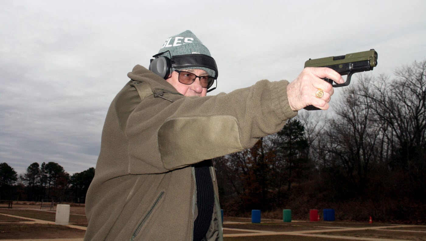 Man demonstrating one handed shooting at the range