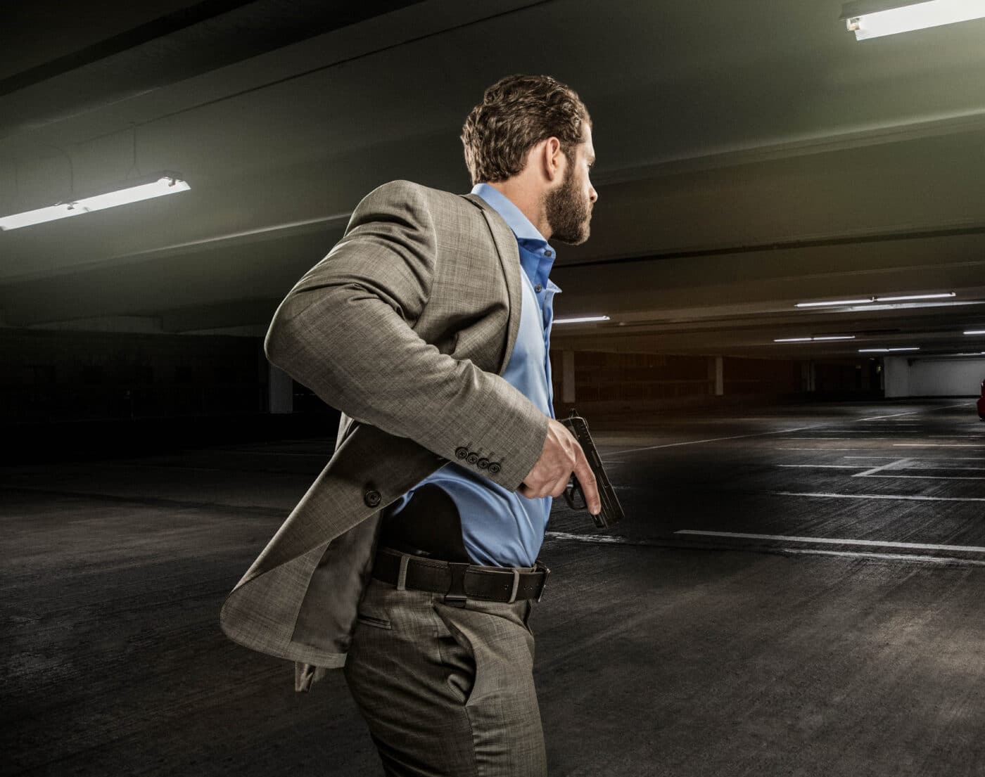Man drawing pistol in self defense in a parking garage