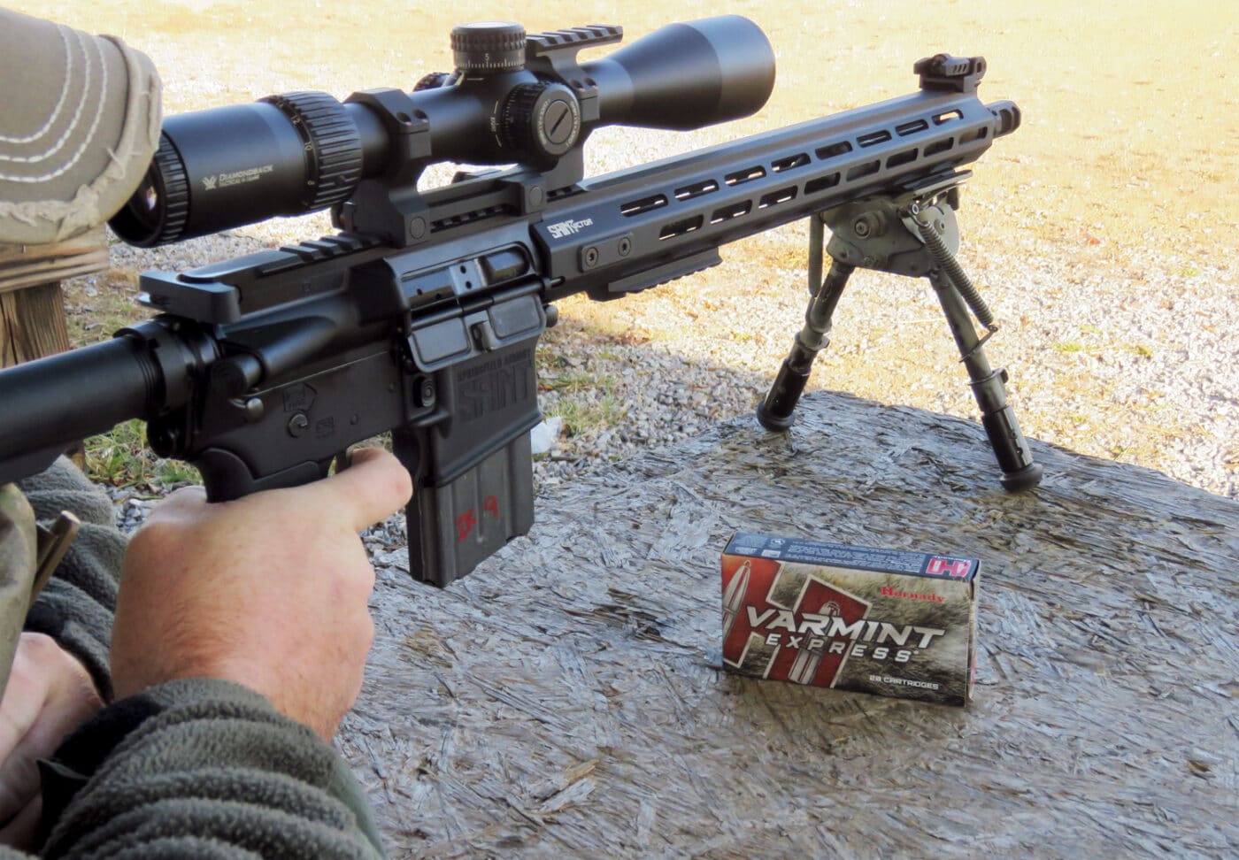 Man shooting Varmint Express through SAINT rifle at the range