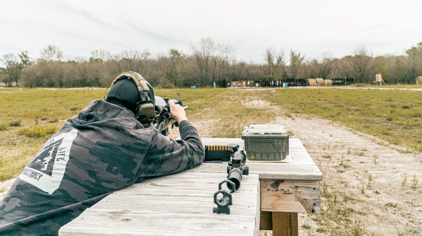 Man testing a rifle scope