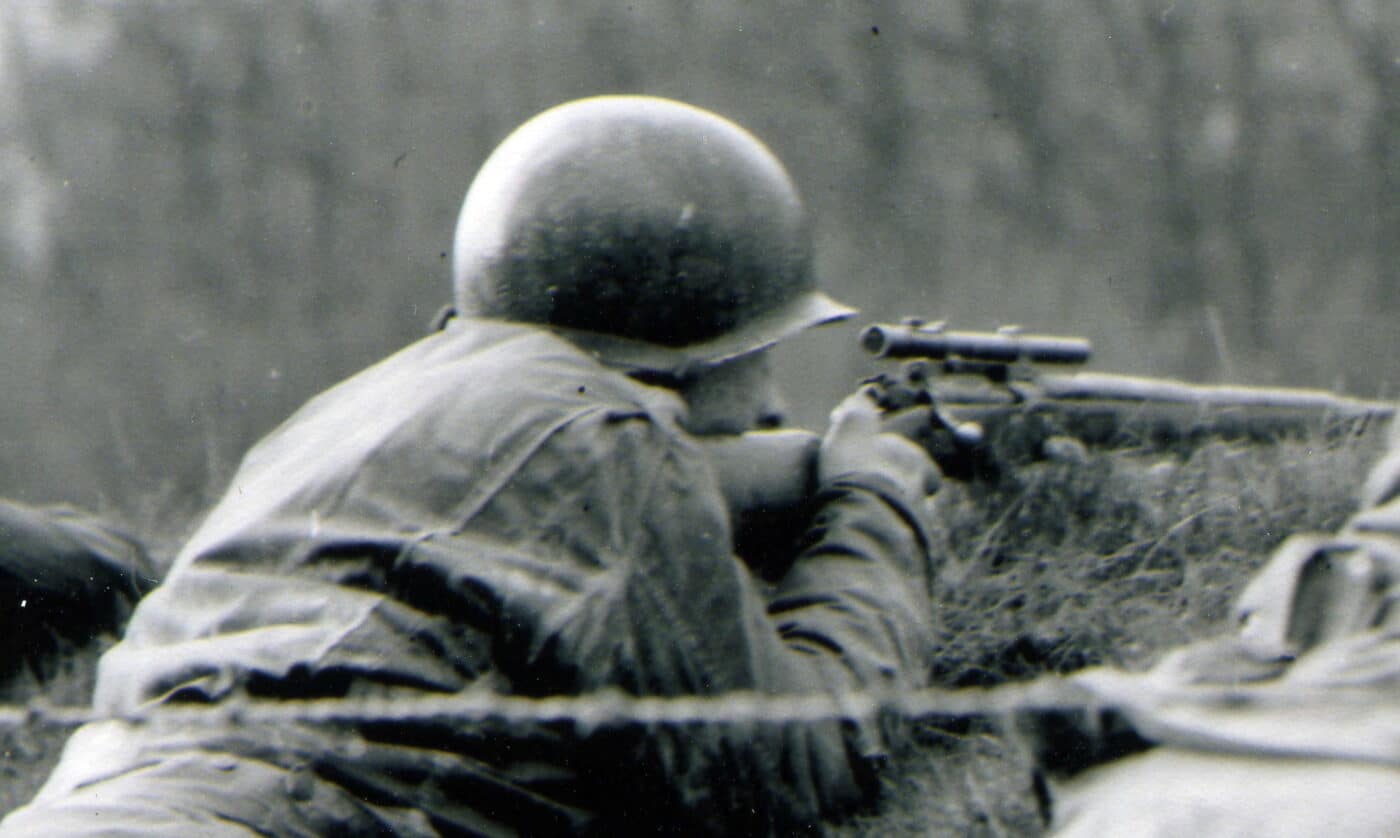 Soldier firing M1903A4 sniper rifle in Northern France during the autumn of 1944