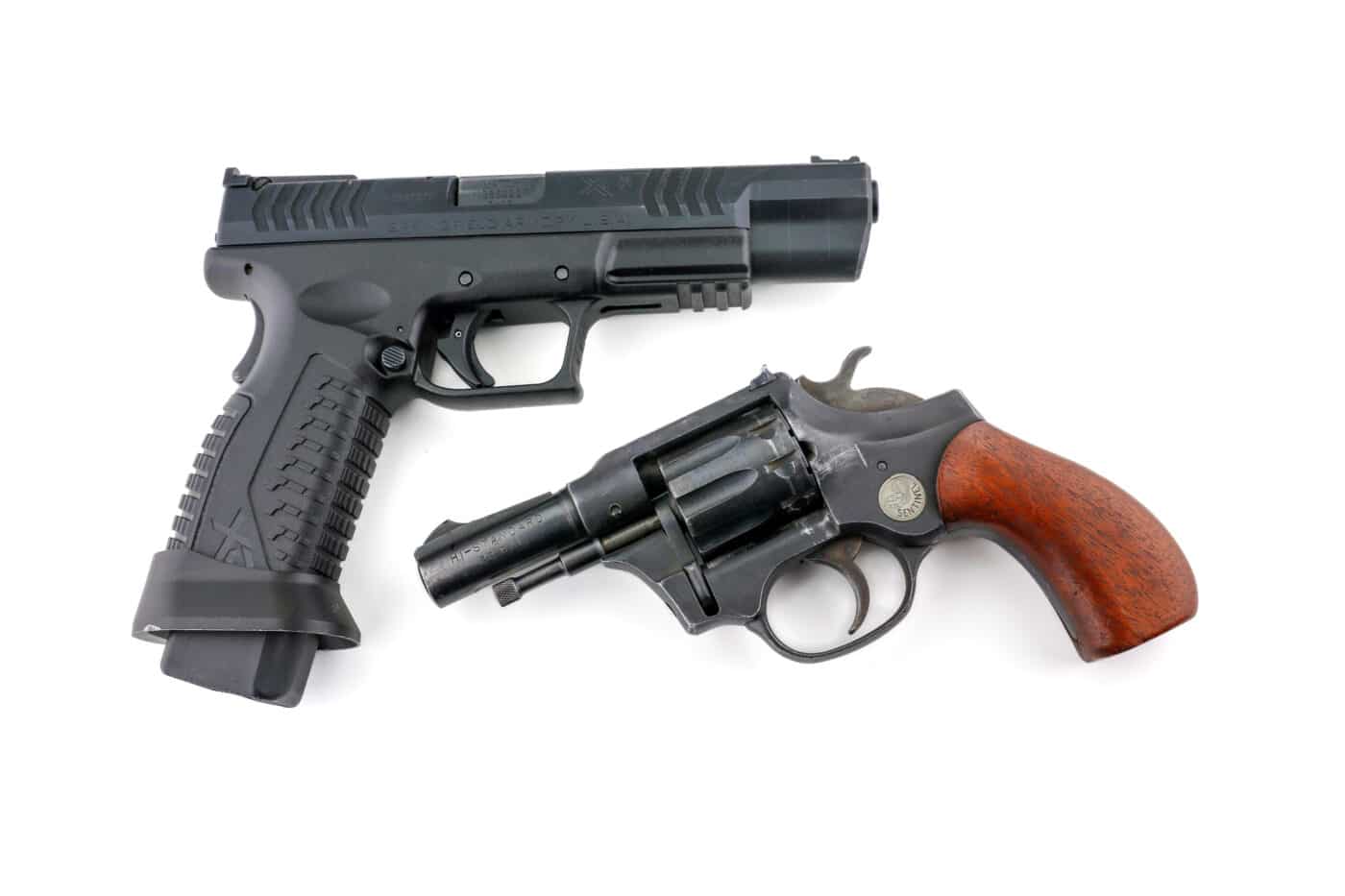 Semiauto pistol next to a revolver