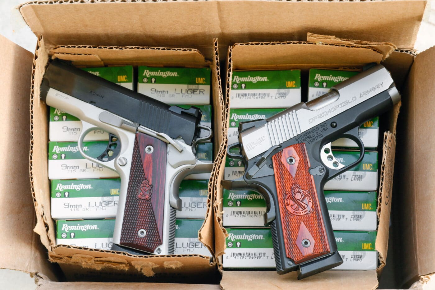 Two Springfield EMP pistols in boxes with ammo
