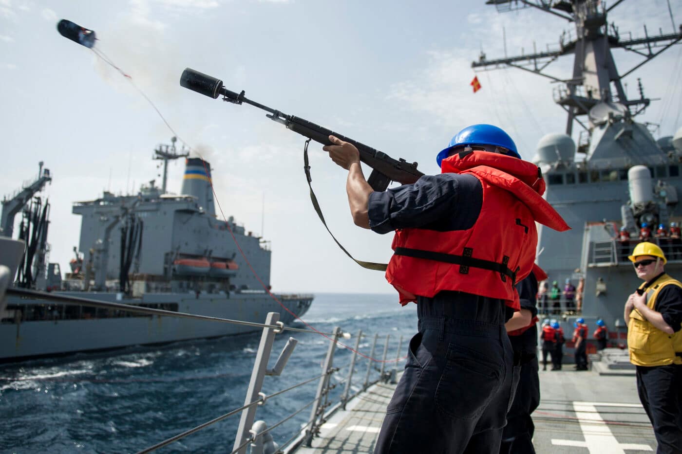 Gunner’s Mate Seaman Jesse Savage fires a shot line from the guided-missile destroyer USS Gonzalez