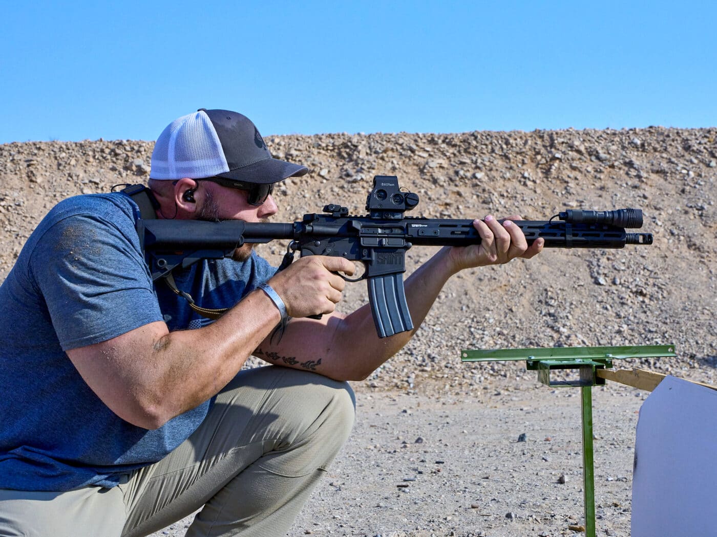 Man shooting Springfield SAINT Victor rifle from a kneeling position