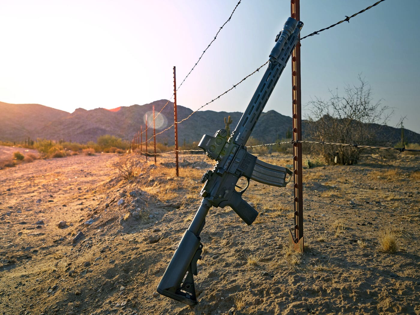 Springfield Armory SAINT Victor rifle leaning against a fence