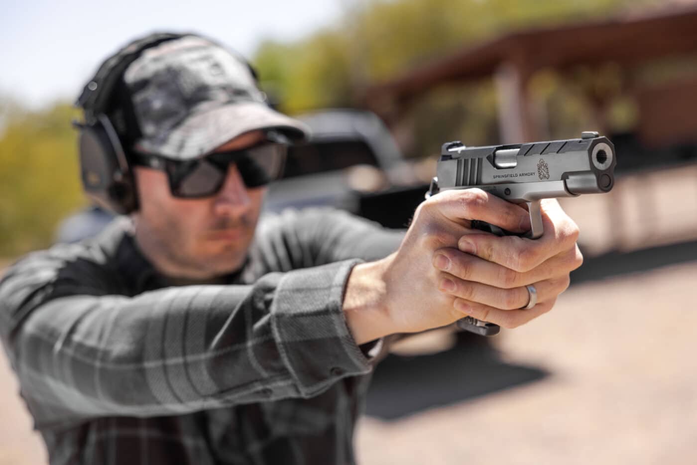 Man conducting initial range evaluation of the Emissary 9mm 4.25" pistol