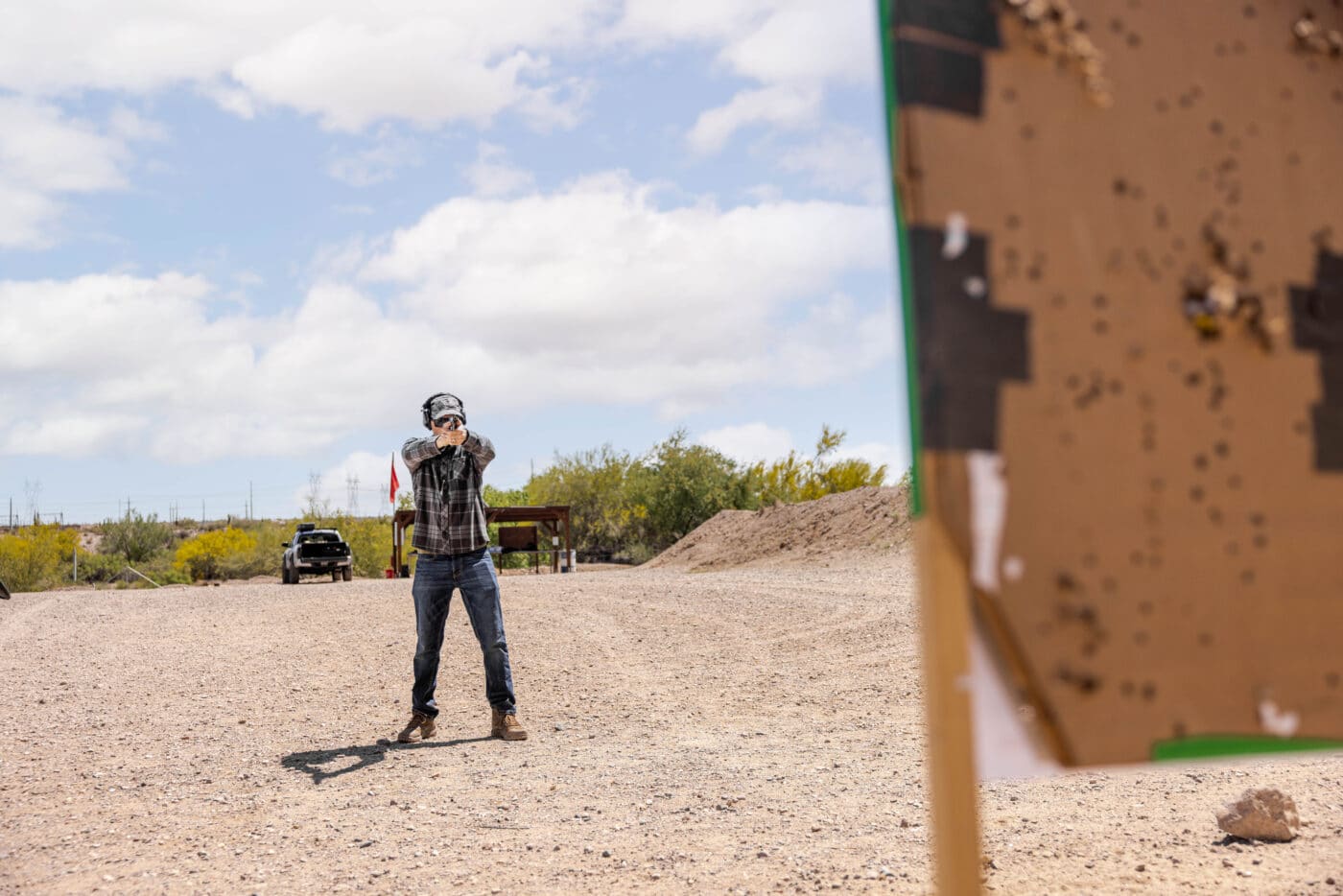 Man shooting a handgun at a range