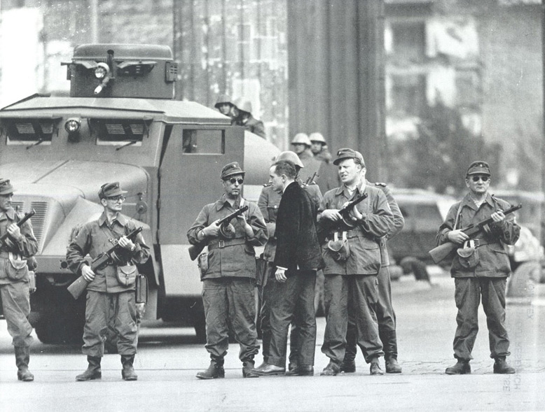 An East Berliner pleads with members of the East German People’s Police as he tried to cross the closed border between East and West Berlin on August 14, 1961