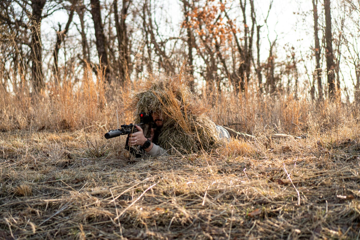 Man using DIY ghillie suit