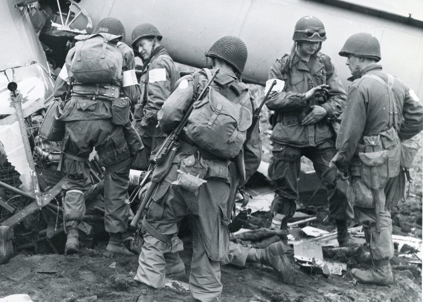 Paratroopers of the 101st Airborne in Normandy, with one of the paratroopers carrying an M1A1 Carbine