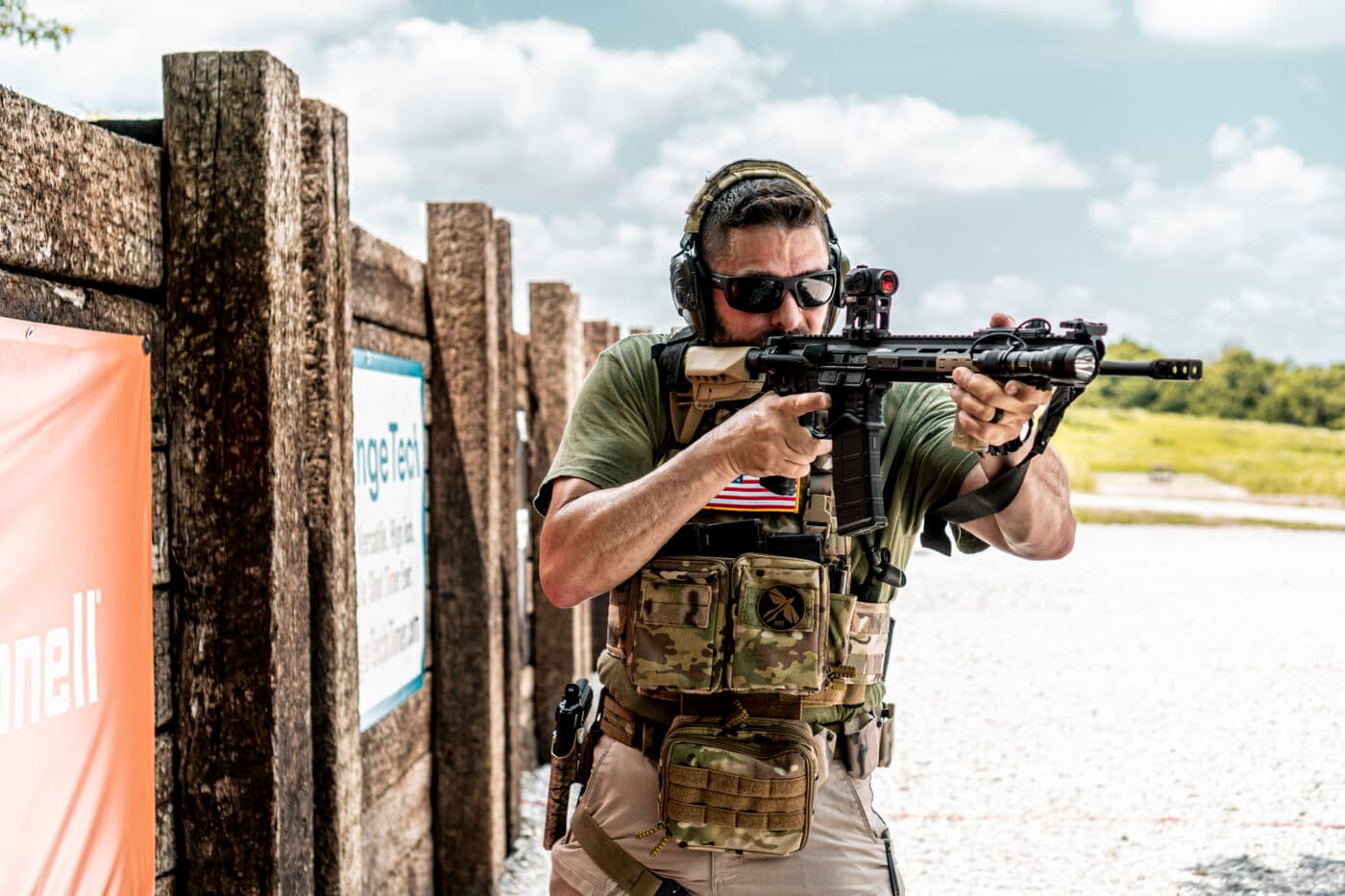 Man shooting rifle while demonstrating how to set up a plate carrier