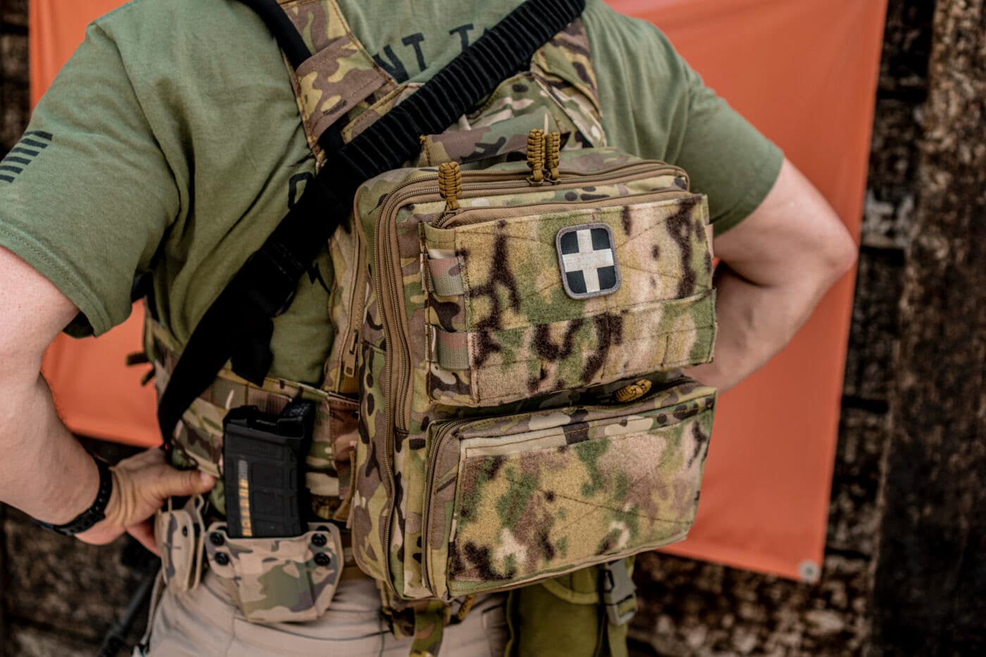 Man equipping the back of a plate carrier