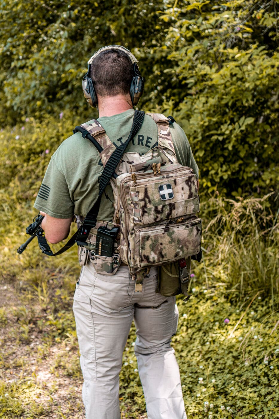 Rear view of man wearing plate carrier with battle belt