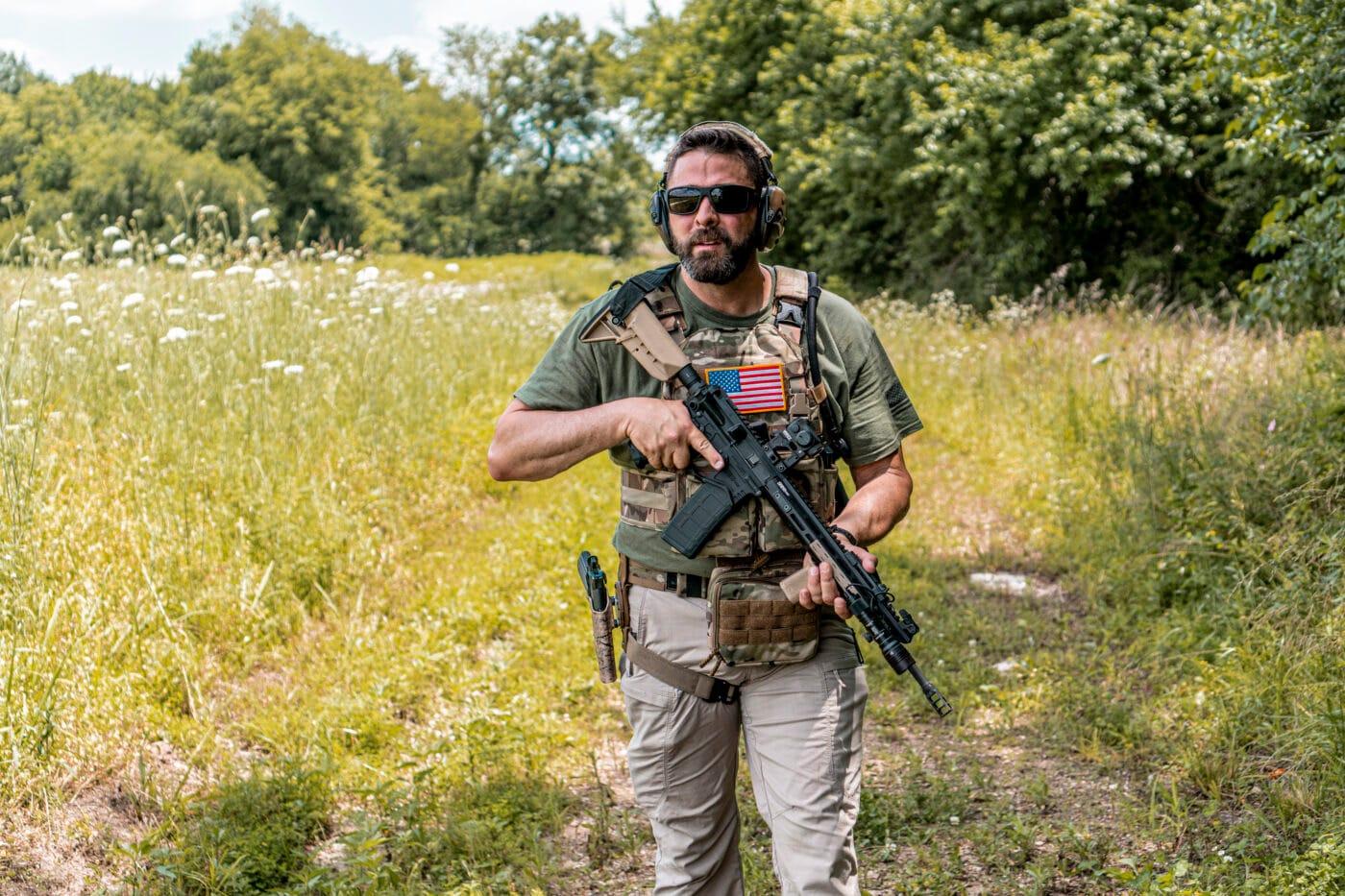 Man carrying rifle and using different plate carrier setups