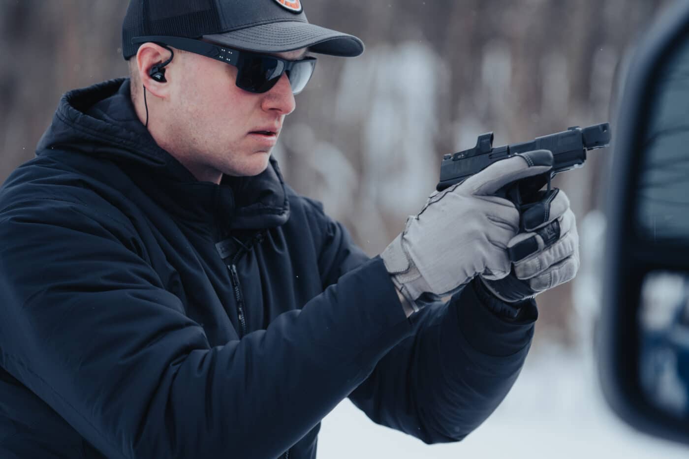 Man reloading pistol behind cover