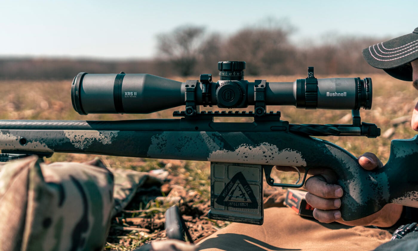 Man setting up scope on a rifle