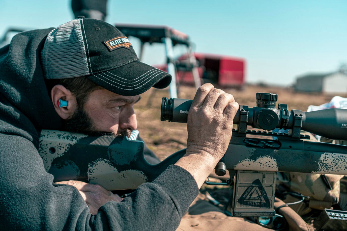 Man figuring rifle scope DOPE