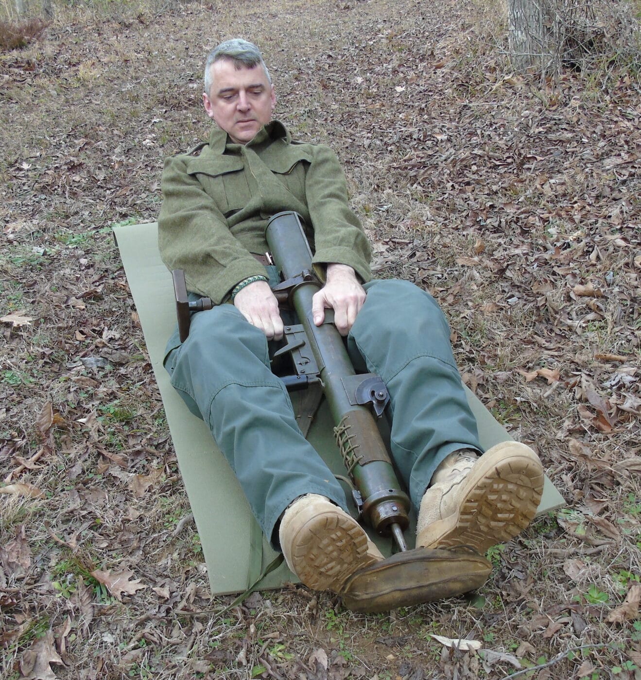 Man cocking an unloaded PIAT gun