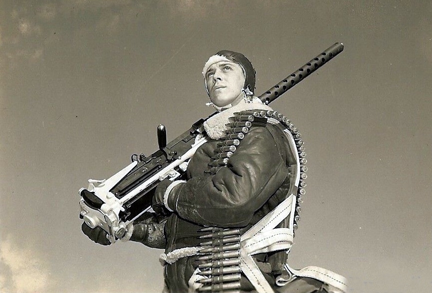 A U.S. air gunner carrying his Browning AN/M2 .50 caliber machine gun