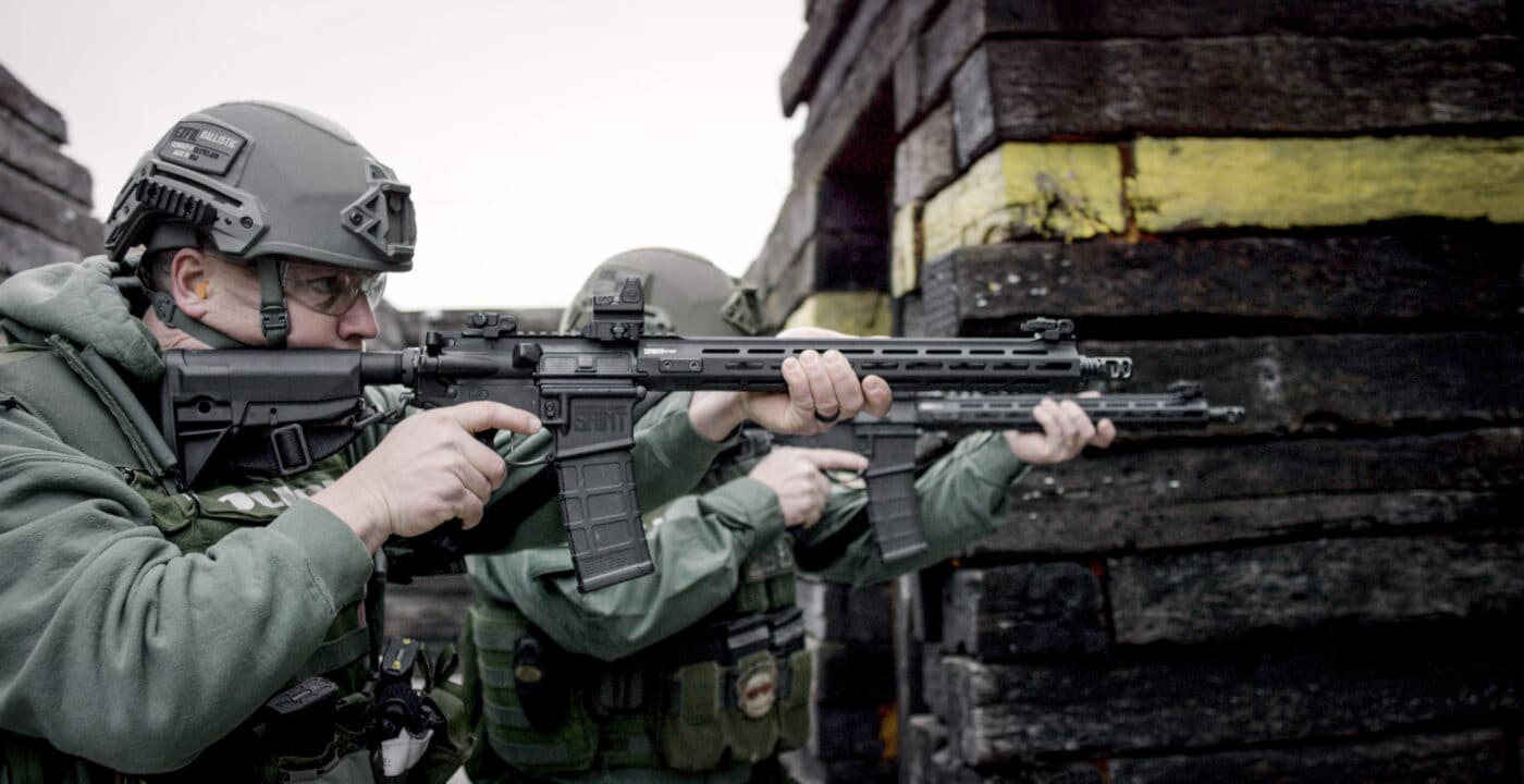 Police with rifle while wearing hard body armor