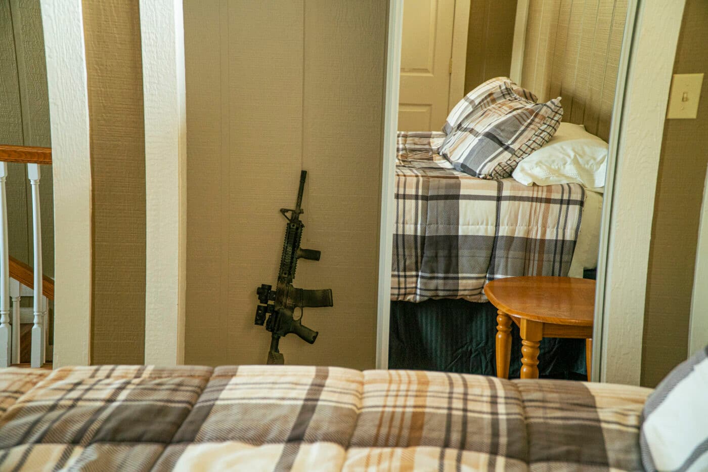 Rifle resting against a wall in a bedroom room