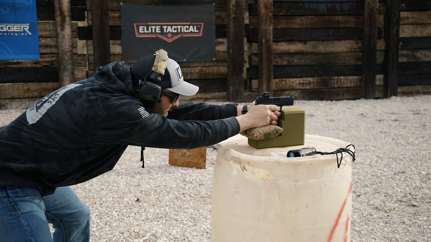 Man shooting pistol from a rest