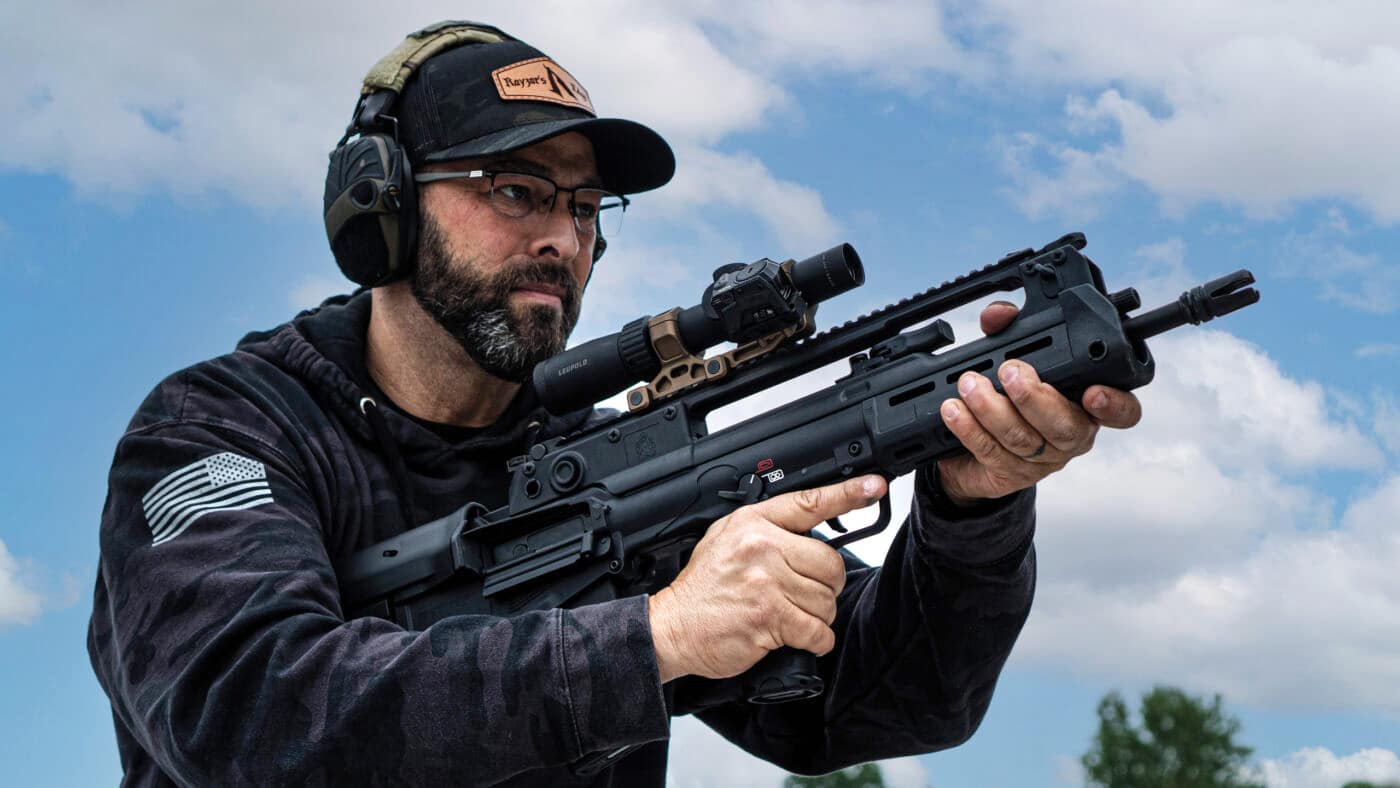 Man holding Springfield Hellion rifle with Leupold Mark 3HD 1.5-4x20mm AR-Ballistic scope during review