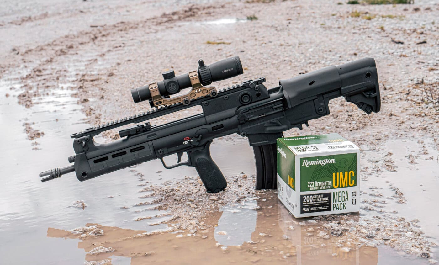 Springfield Hellion rifle with Leupold scope mounted next to box of Remington ammo used in testing