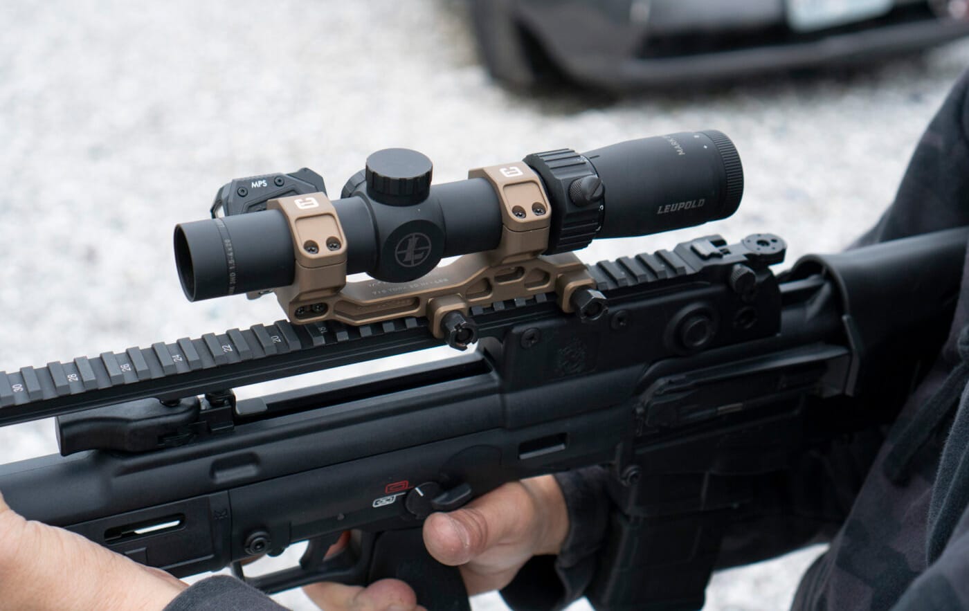 Man holding Springfield Hellion rifle with Badger Ordnance Condition 1 Mount and Leupold scope