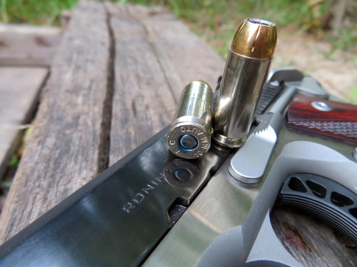 Detail of 10mm ammo resting on top of Springfield Armory 10mm Ronin 1911 pistol