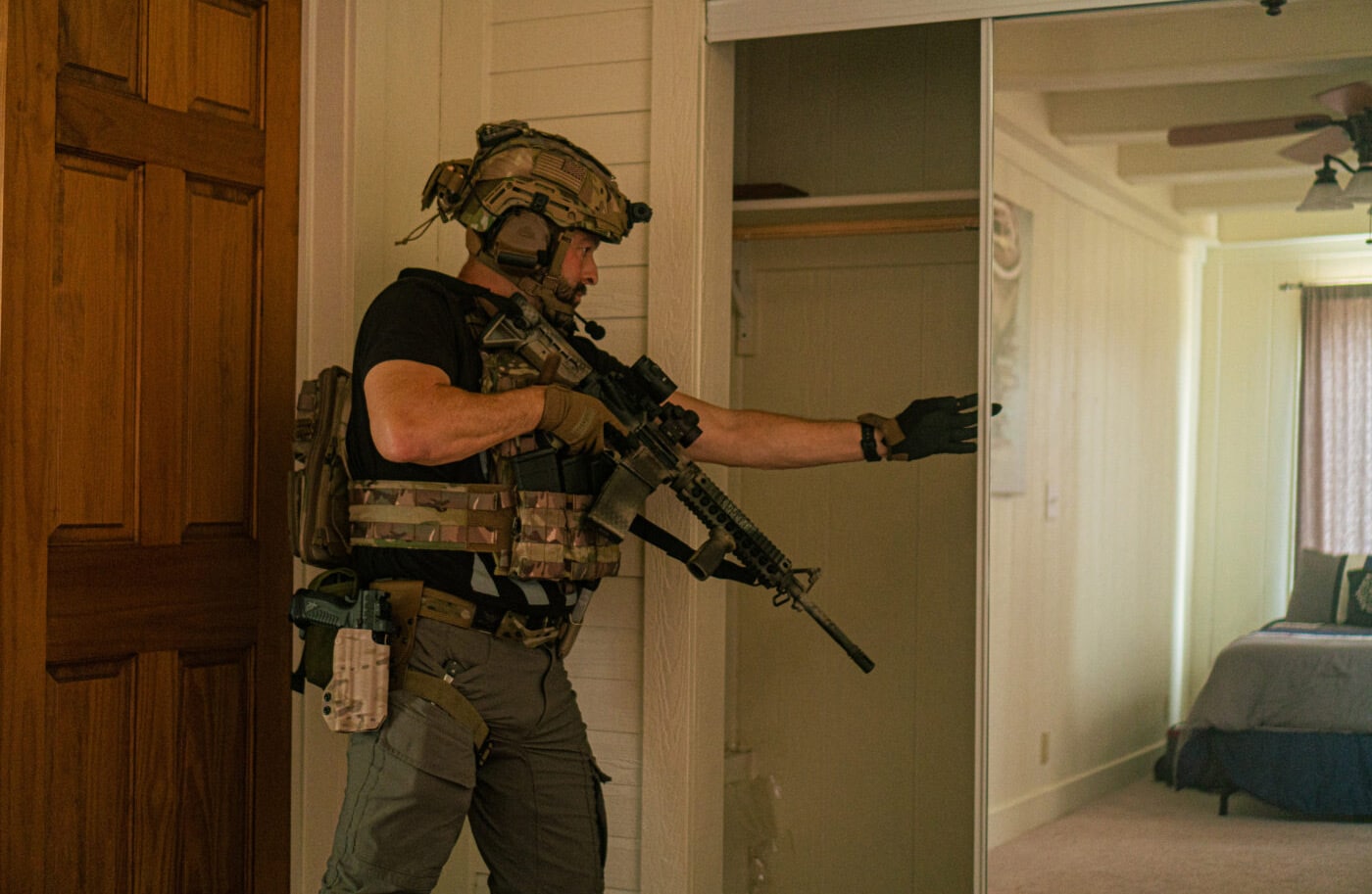 Man looking into a closet while clearing a house