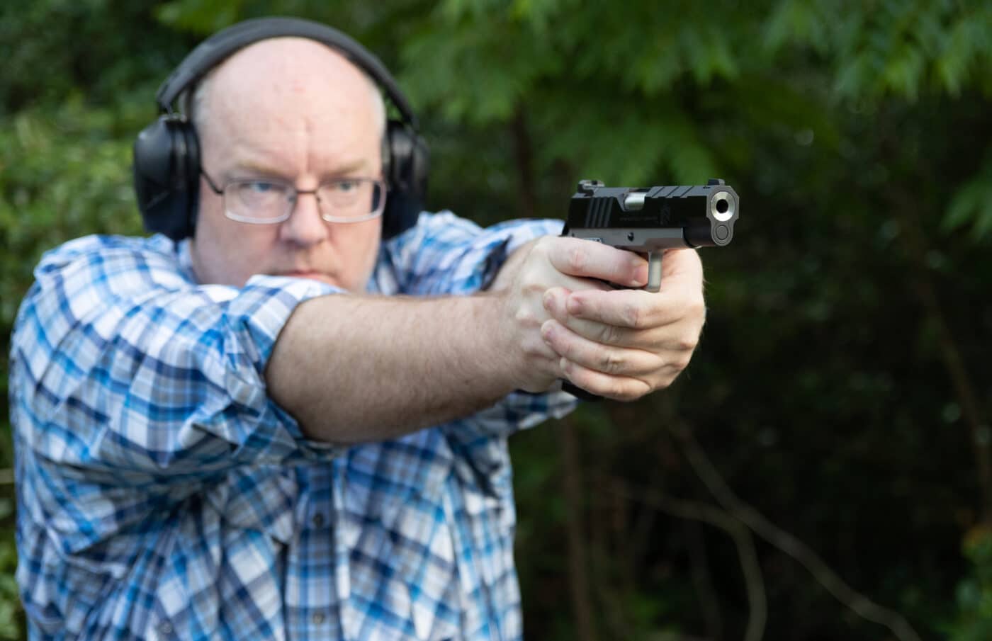 Man testing the Springfield Emissary 9mm Commander 4.25" pistol on the range