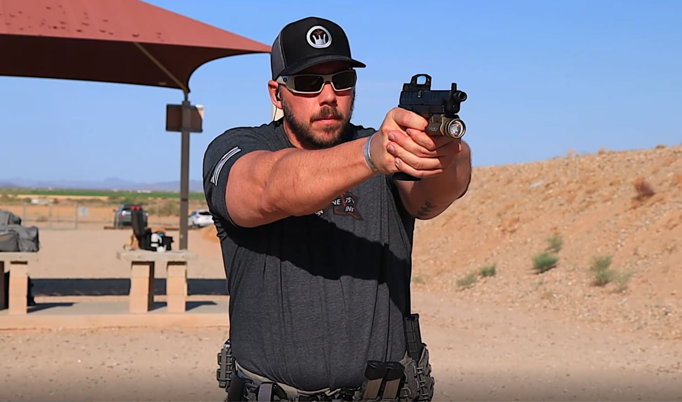 Man presenting pistol and pressing trigger slowly during practice at the range