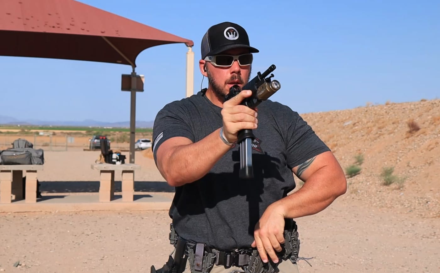 Man demonstrating magazine release from semi-auto pistol