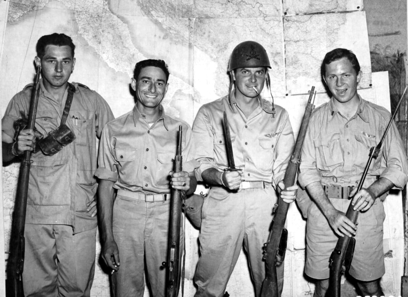 Soldiers pose with Italian rifles captured in Sicily in 1943 during WWII