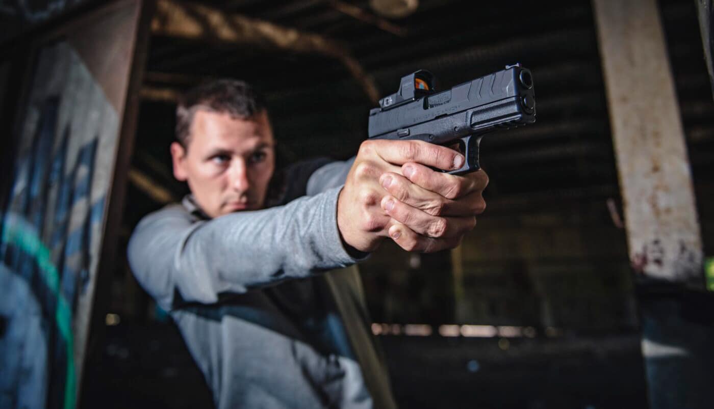 Man shooting a pistol during 21 foot rule Tueller Drill training